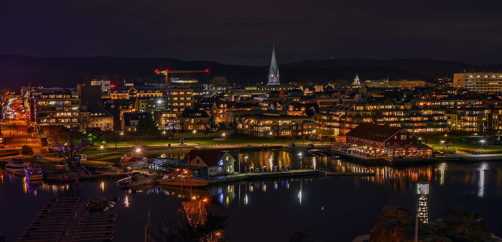 A Stunning Sunset Over Kristiansand Harbor Wallpaper