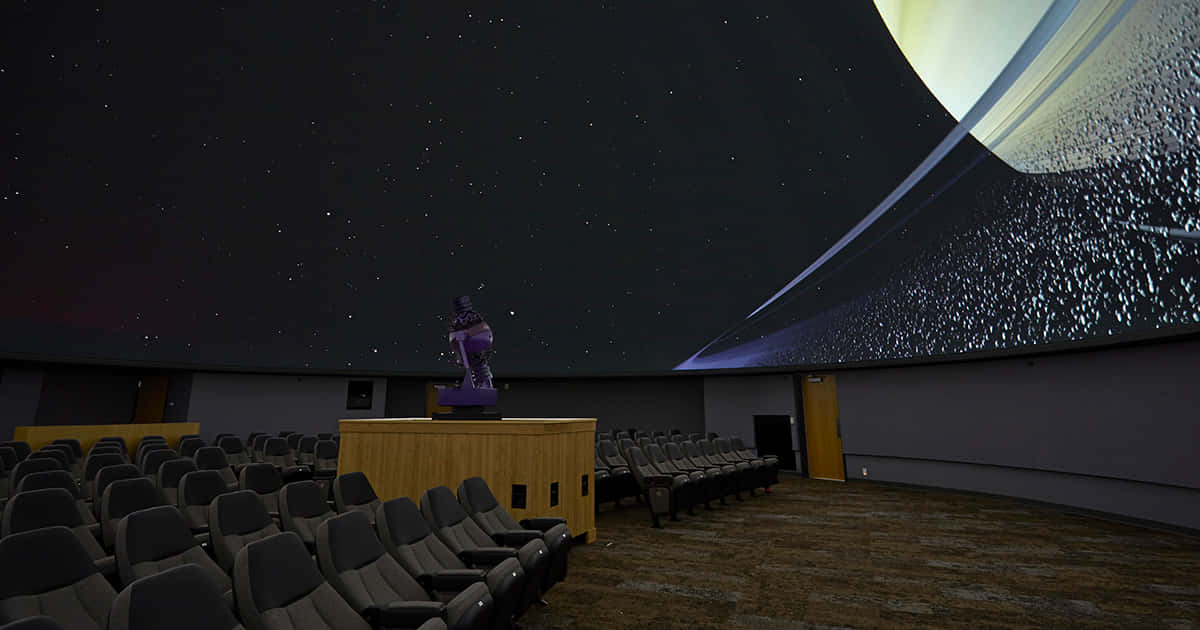 A Stunning View Of The Night Sky In A Planetarium Wallpaper