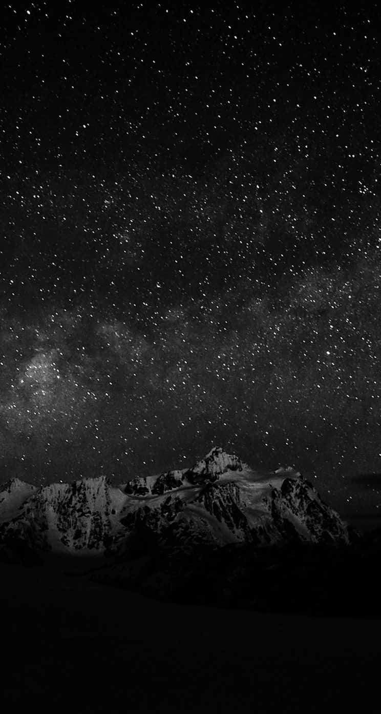 A Stunning View Of The Starry Night Under A Dark Sky Wallpaper