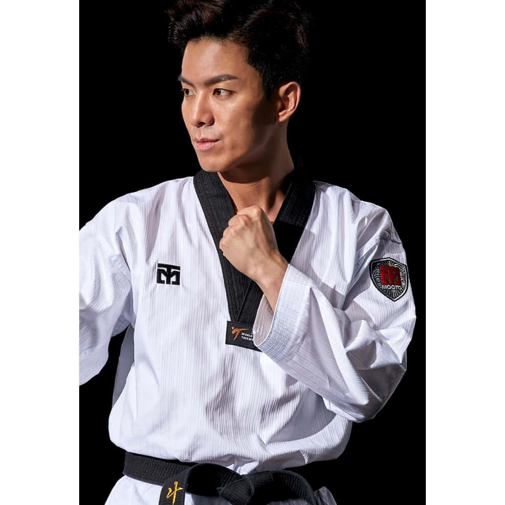 A Taekwondo Instructor With His Training Uniform Wallpaper