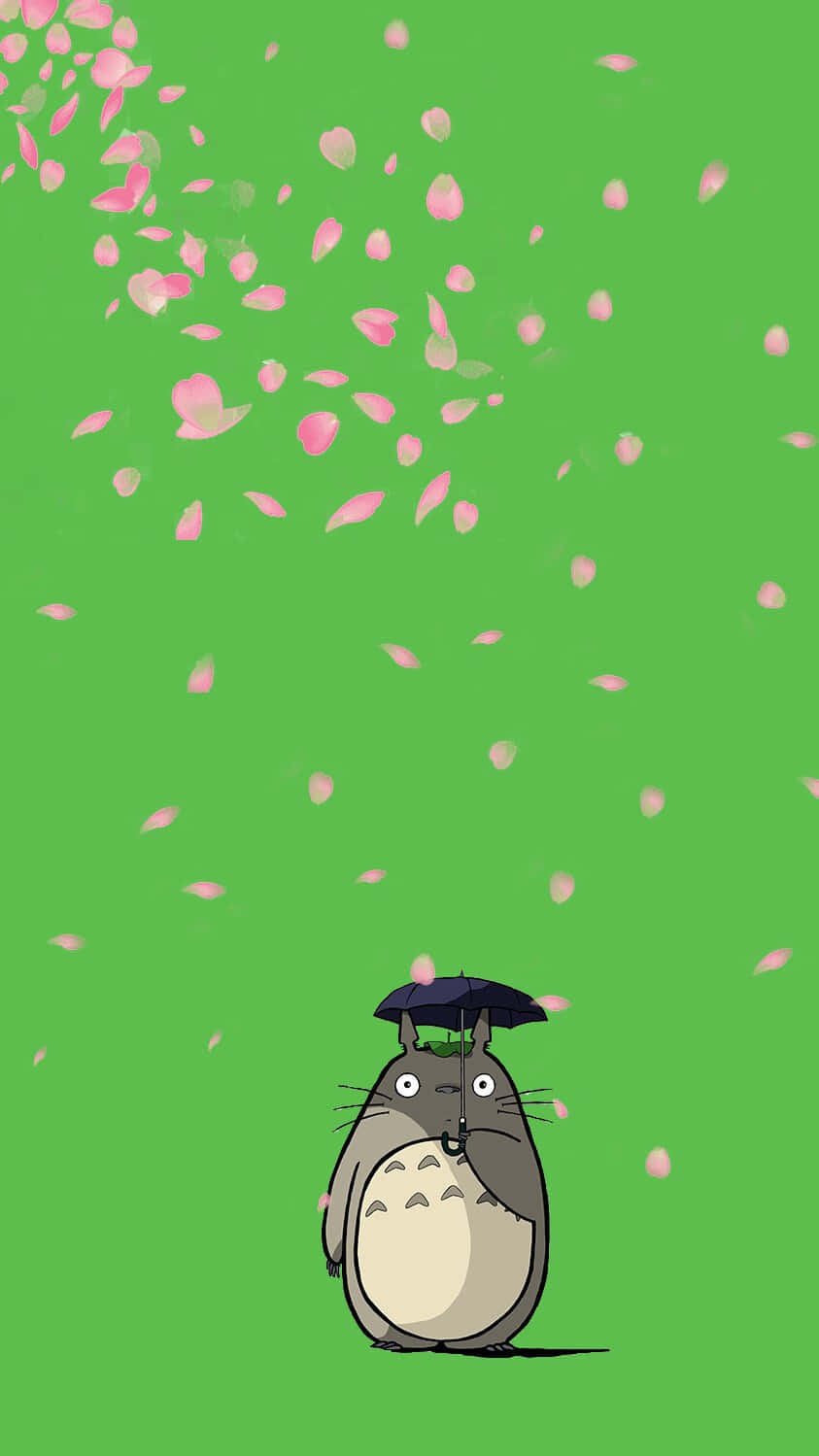 A Totoro With A Hat Flying In The Air Wallpaper