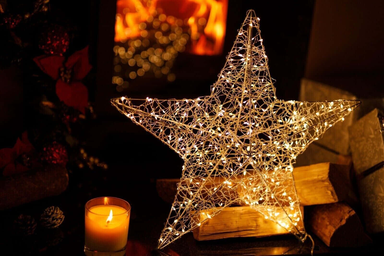 A Twinkling Silver Christmas Star Lights Up The Night Sky. Wallpaper