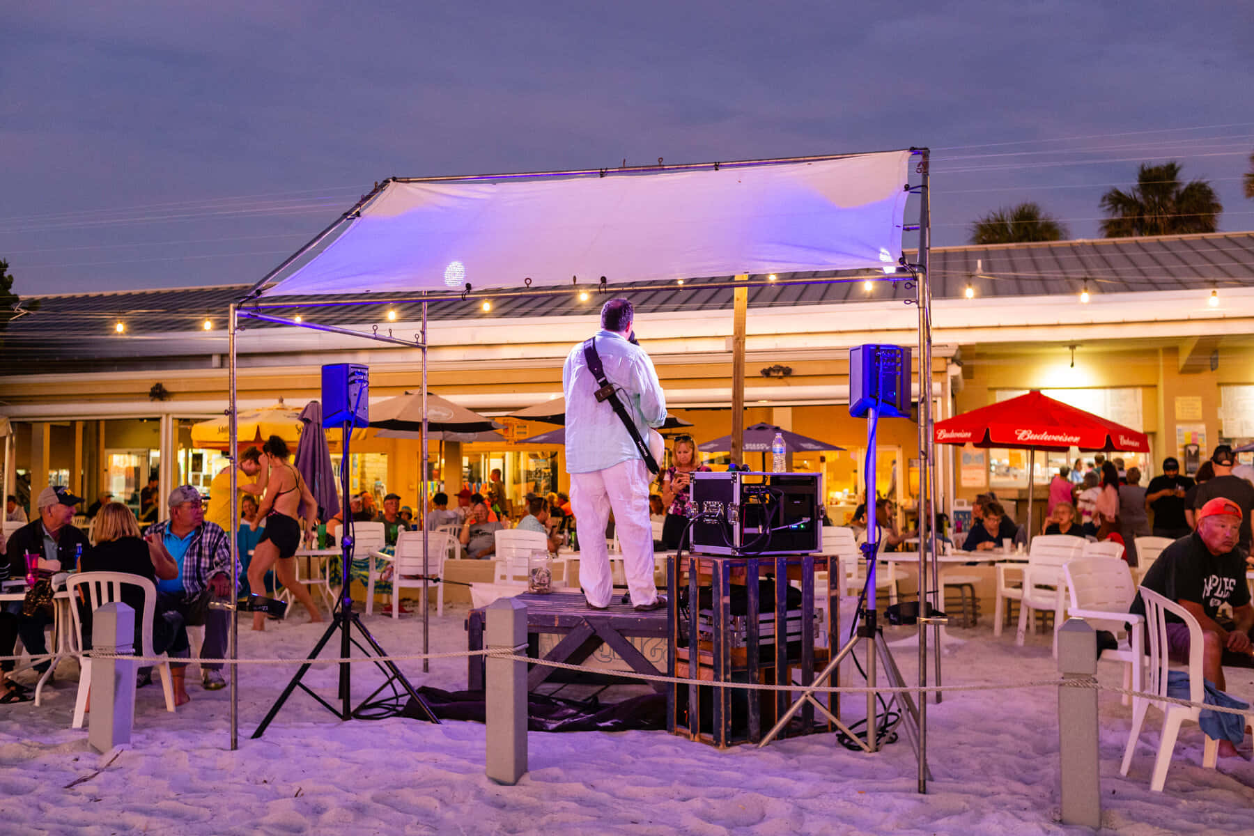 A Vibrant Beach Party At Sunset Wallpaper