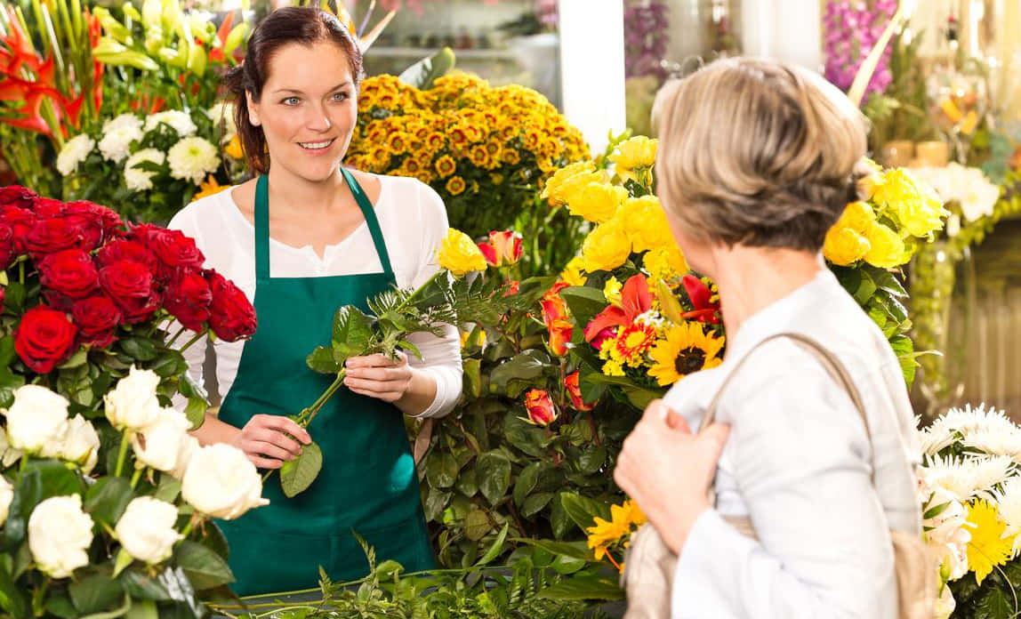 A Vibrant Bouquet Of Roses And Other Colorful Flowers Arranged By A Professional Florist. Wallpaper