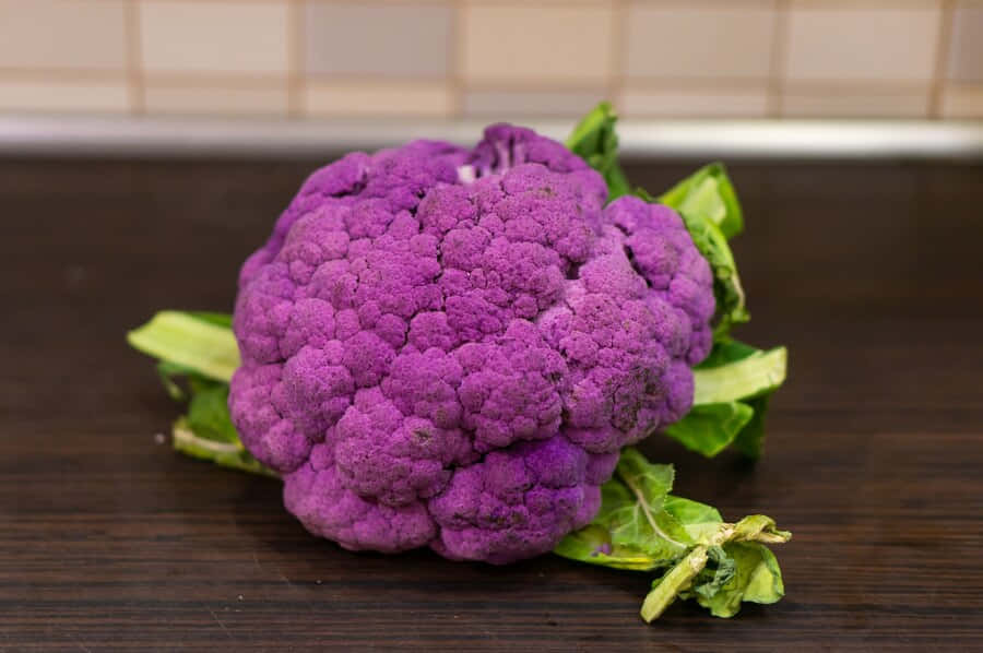 A Vibrant Purple Cauliflower Against A White Background Wallpaper