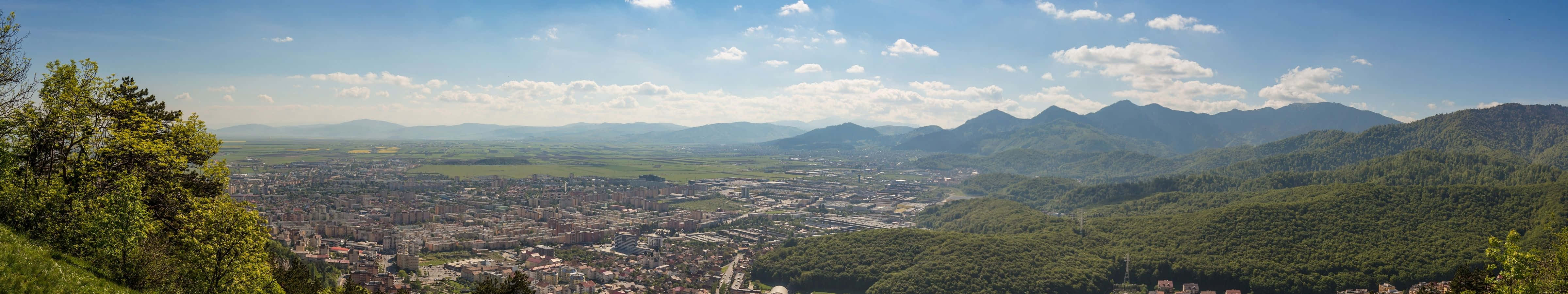 A View Of A City And Mountains Wallpaper