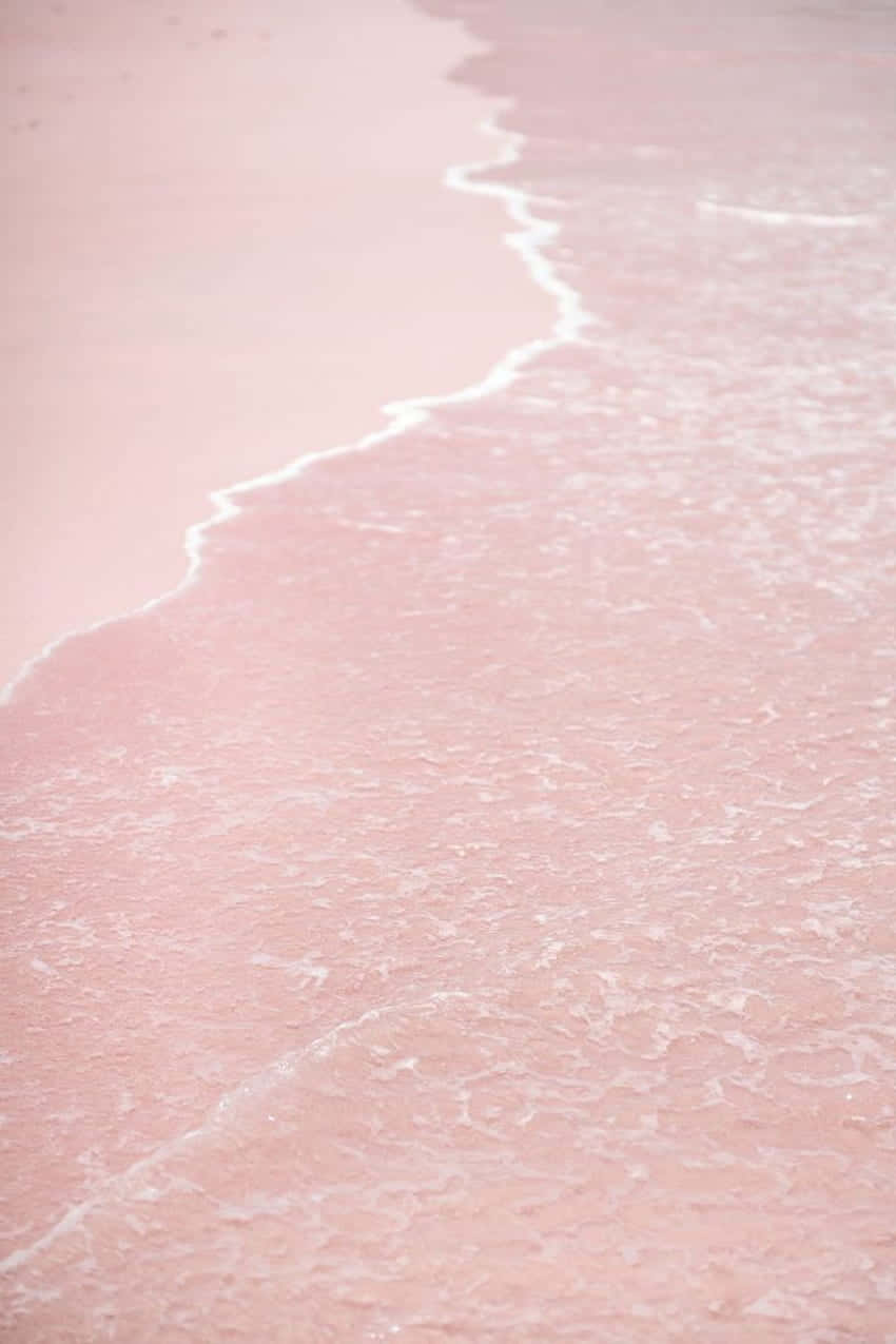 A View Of A Stunning Pink Sunset Beach. Wallpaper