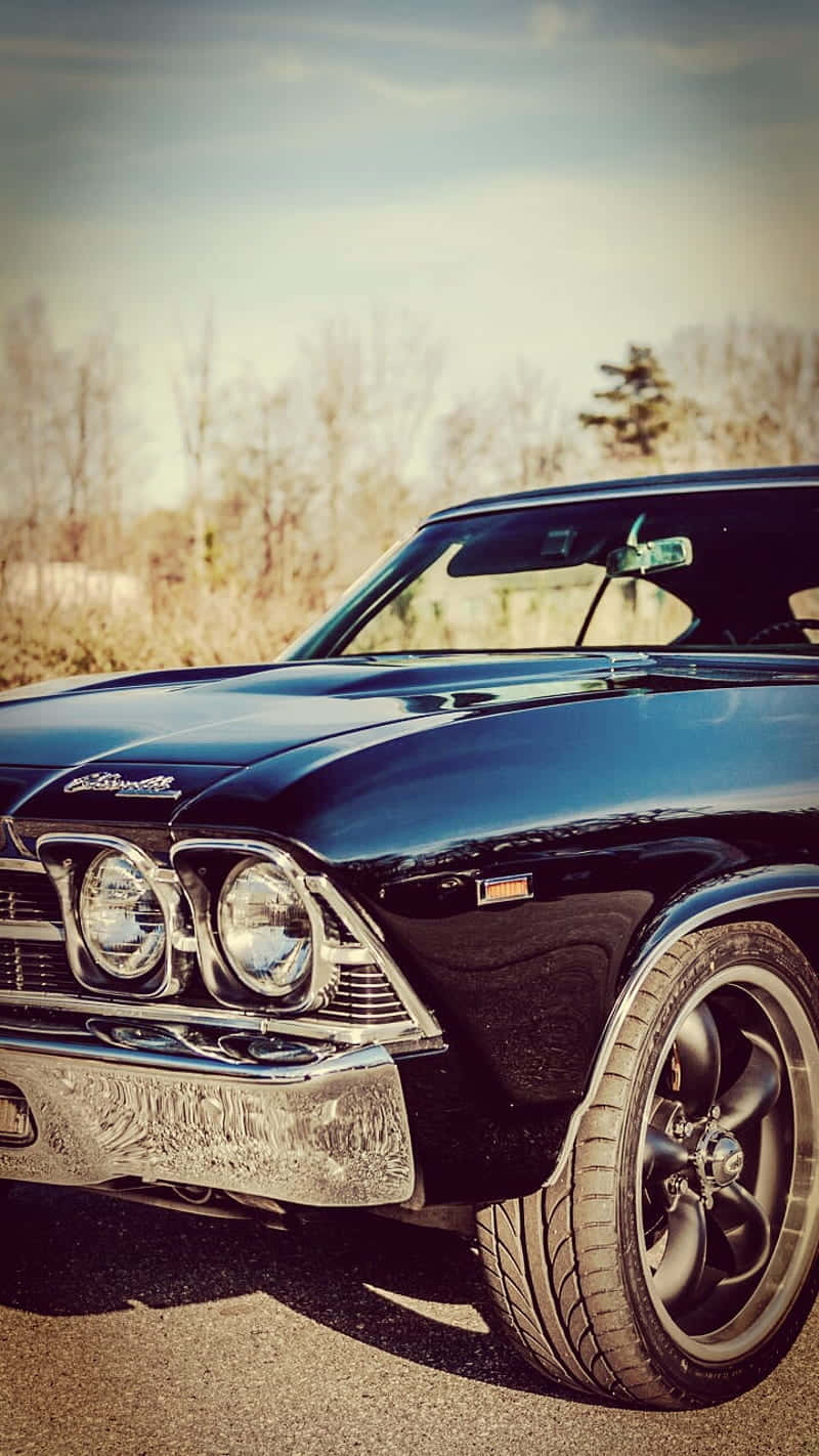 A Vintage Car Revs Its Engine Ready For Adventure Wallpaper