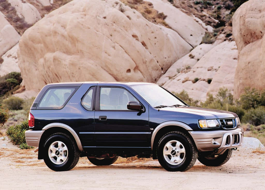 A Well-maintained Classic Isuzu Amigo Parked In An Open Field Wallpaper