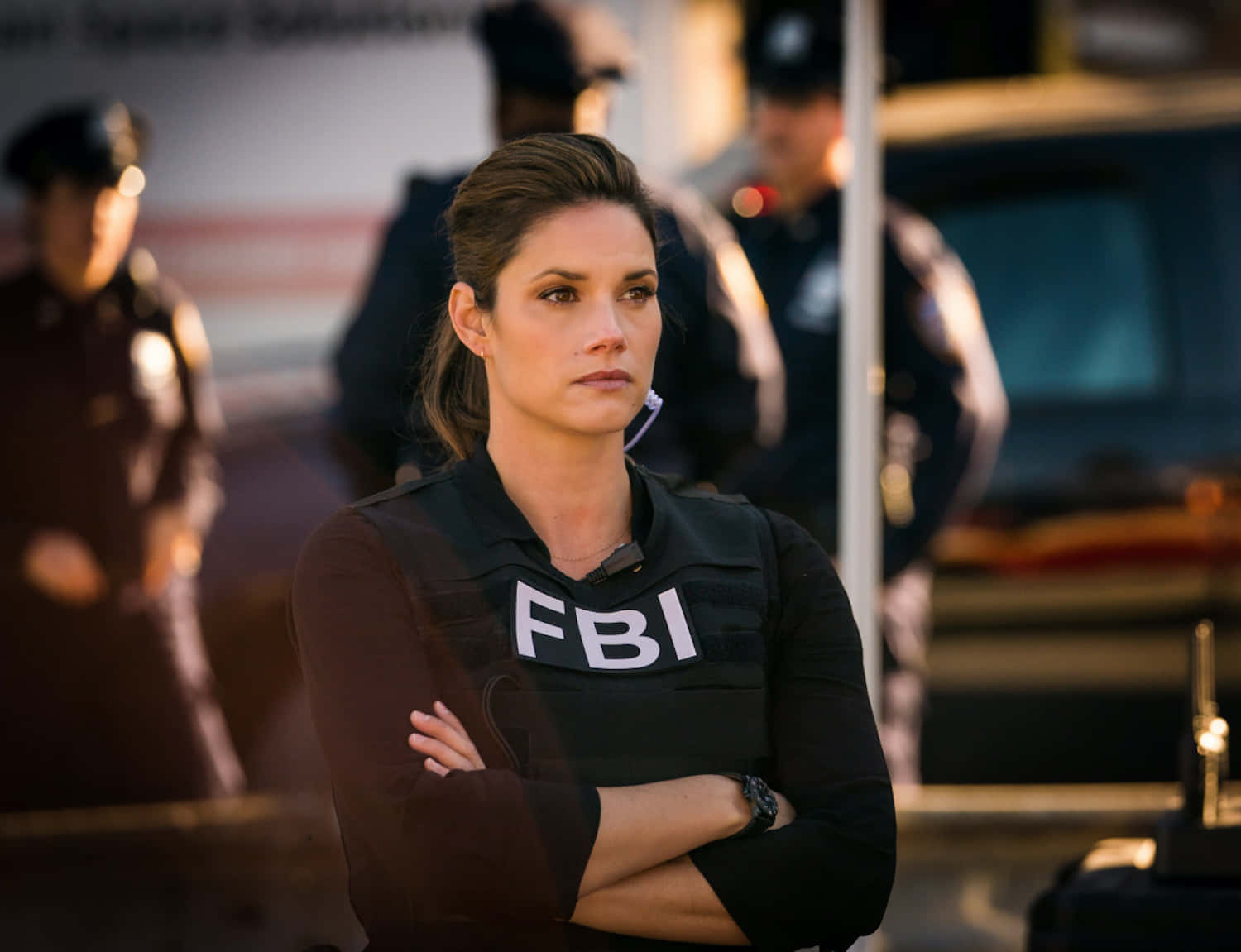 A Woman In A Police Uniform Standing In Front Of Police Officers Wallpaper