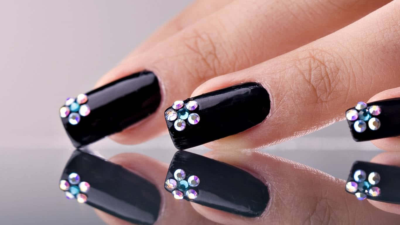 A Woman's Hand With Black Nails Decorated With Crystals Wallpaper