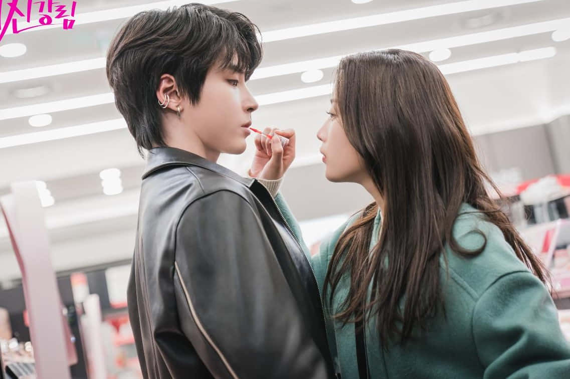 A Young Couple In A Store Looking At Each Other Wallpaper