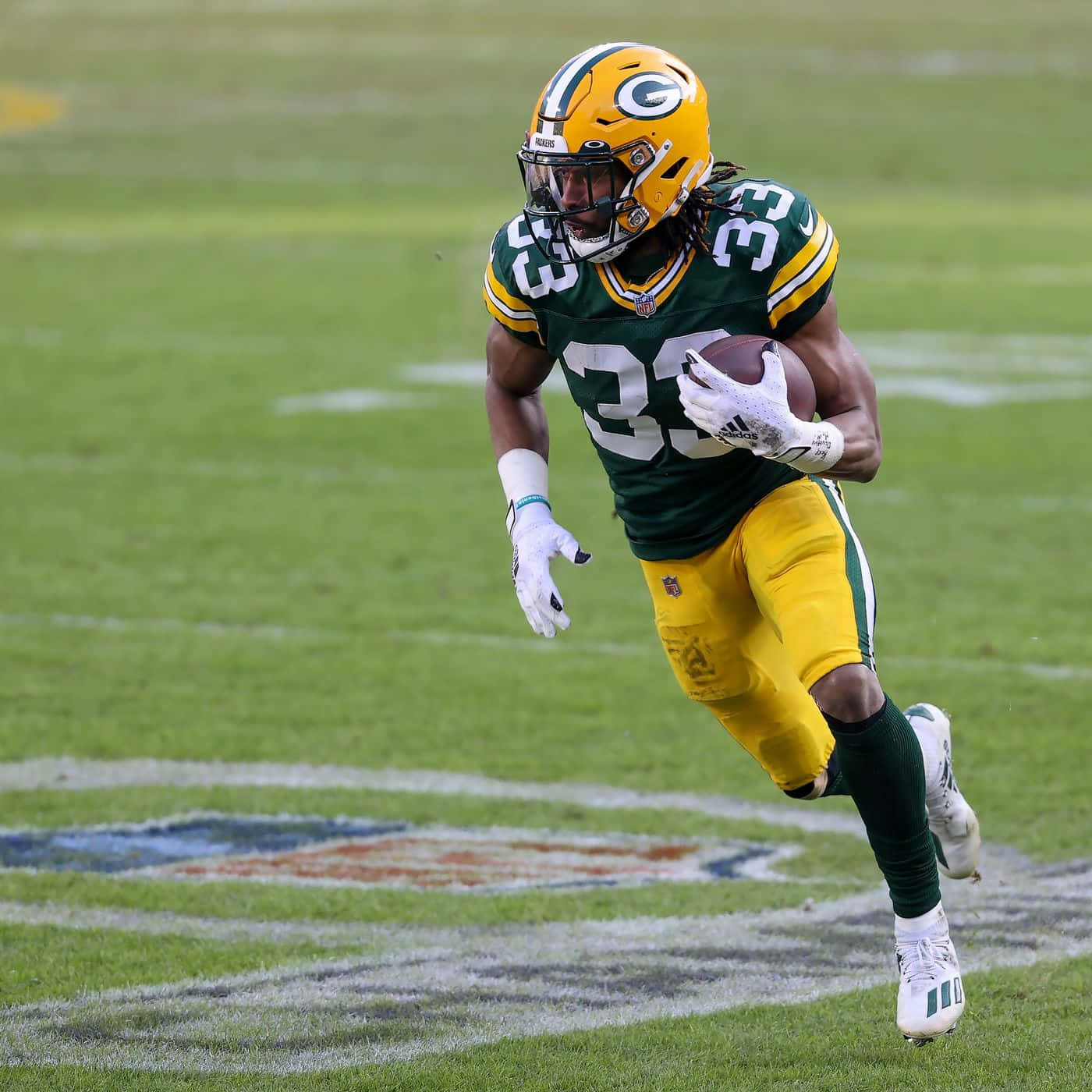 Aaron Jones #12 Of The Green Bay Packers Running With The Ball Wallpaper