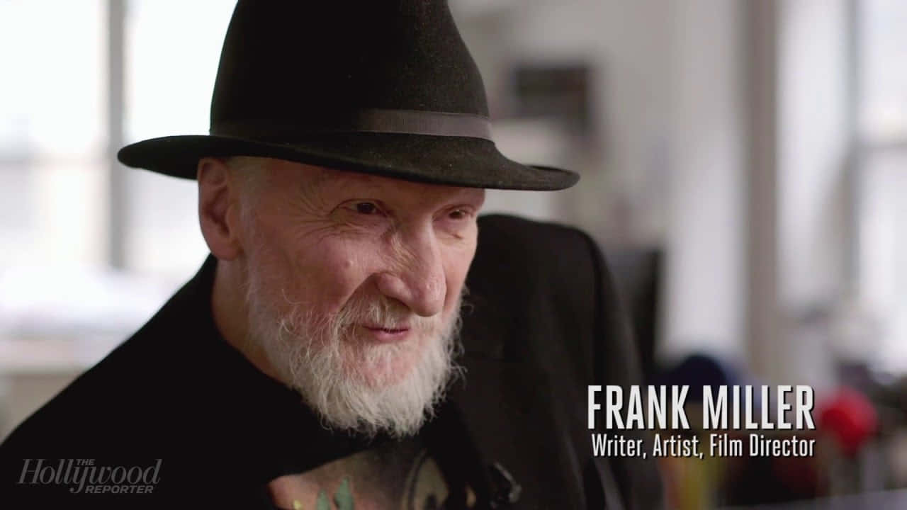 Acclaimed Comic Book Writer Frank Miller Holding A Pen And Sketchbook Wallpaper