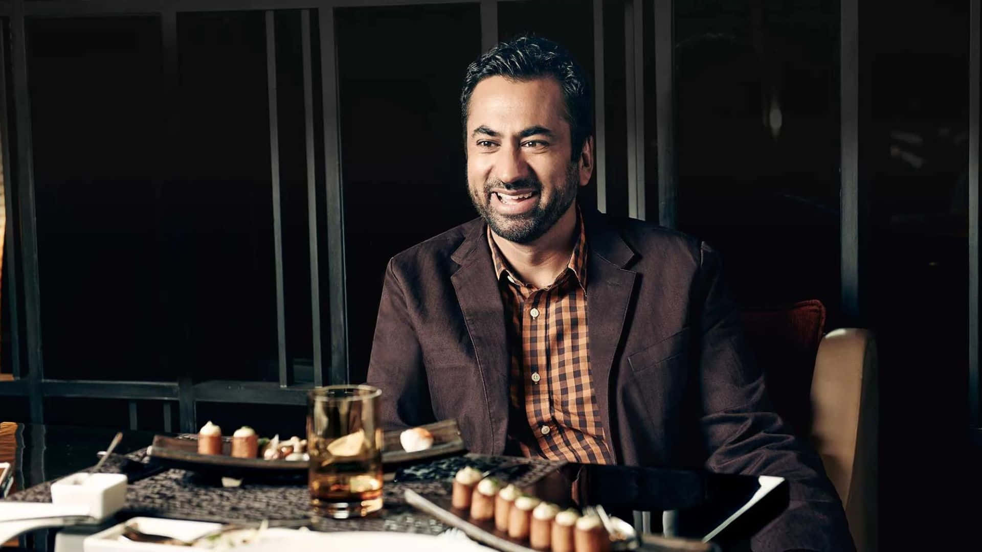 Actor Kal Penn Posing For A Photoshoot Wallpaper