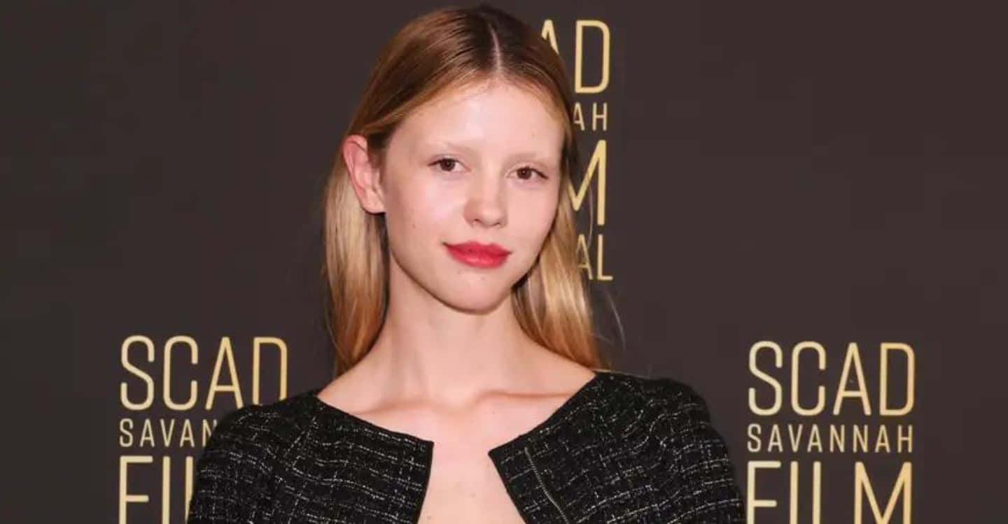 Actress Mia Goth Radiating Elegance In A Black Dress Wallpaper