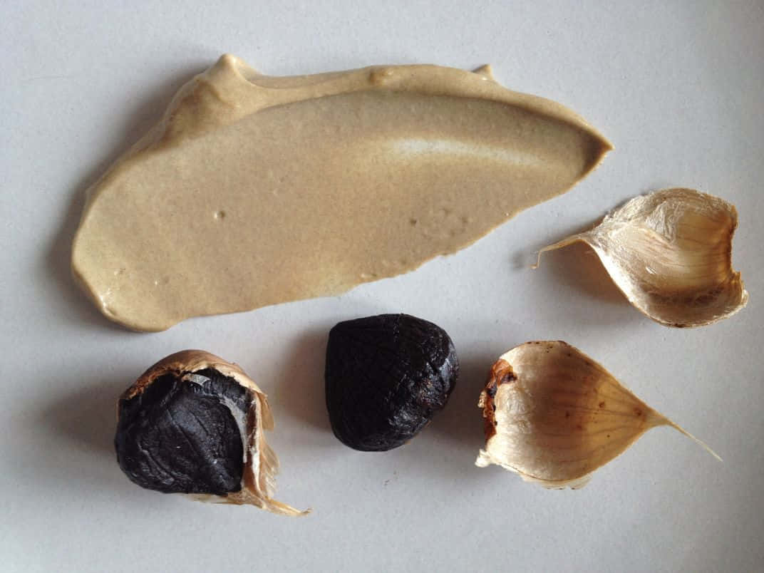 Add Some Delicious And Nutritious Flavor To Your Meals With Black Garlic Wallpaper