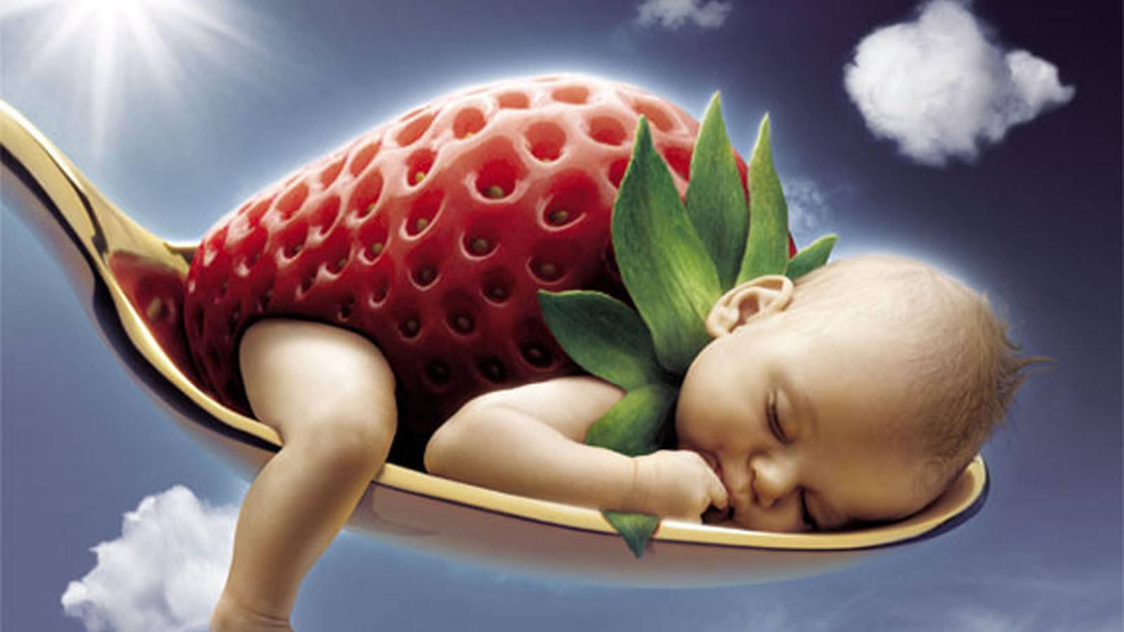 Adorable Baby In A Strawberry Outfit Laughing Joyously Wallpaper