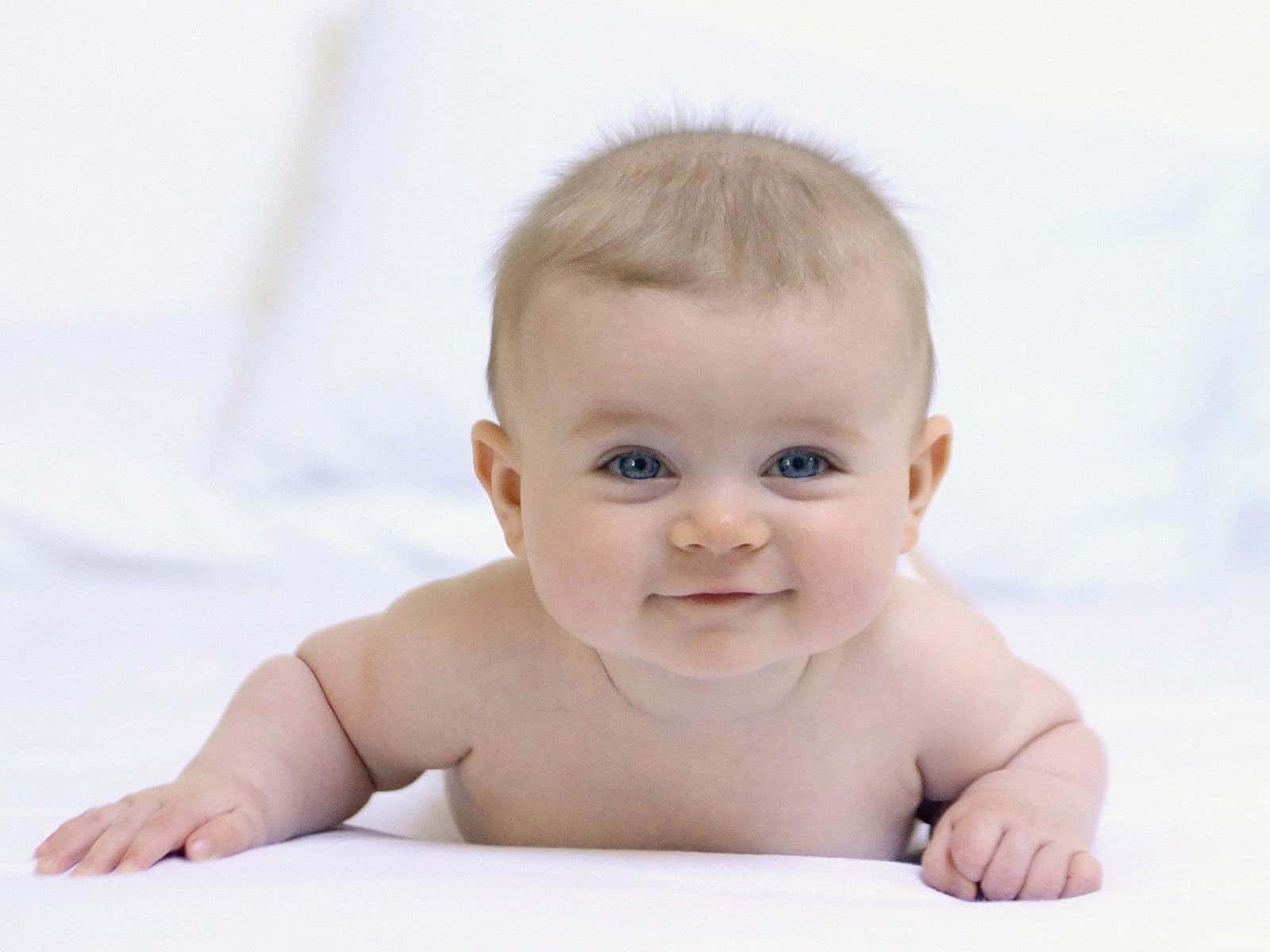 Adorable Baby On White Backdrop Wallpaper