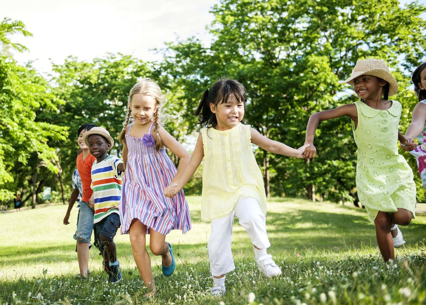 Adorable Kids Smiling And Playing In The Park Wallpaper