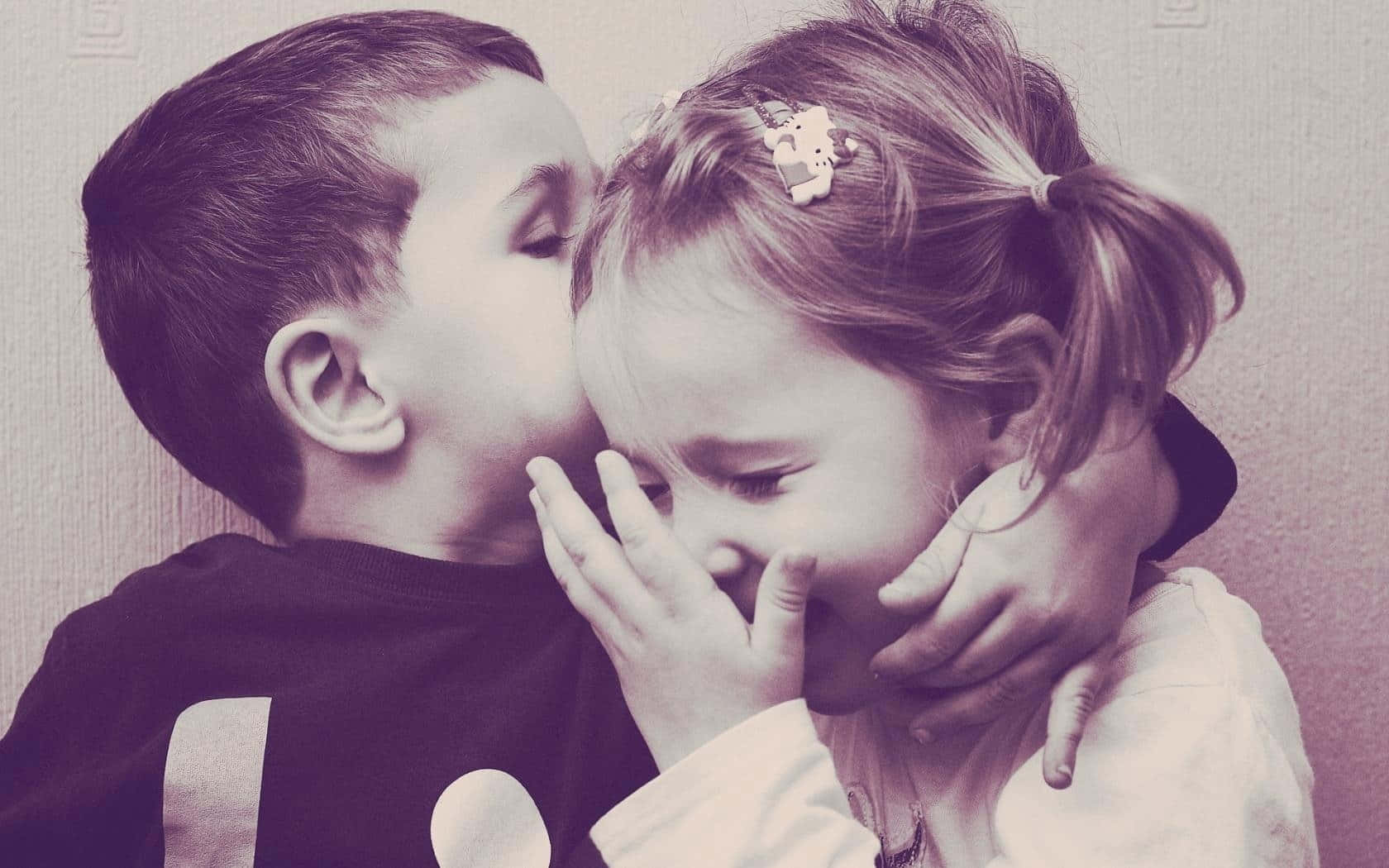 Adorable Toddler Siblings Sharing A Playful Moment Wallpaper