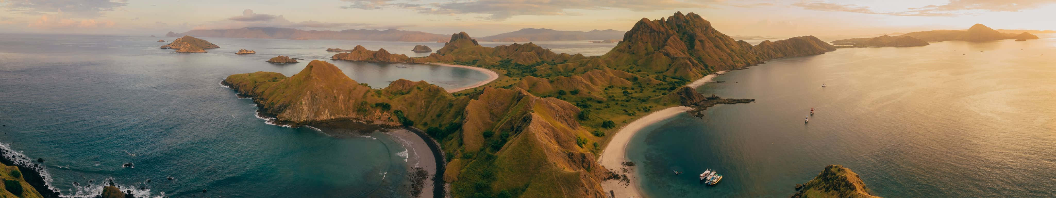 Aerial View Of A Beautiful Island With A Boat In The Water Wallpaper