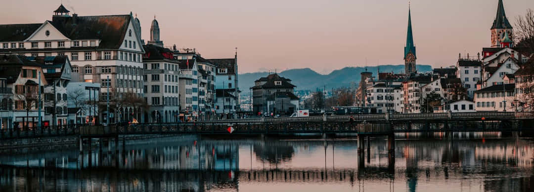 Aerial View Of Picturesque Zurich And Limmat River At Sunset Wallpaper