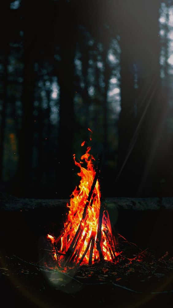 Aesthetically Pleasing Red And Yellow Fire Blazing Brightly Against A Dark Background Wallpaper