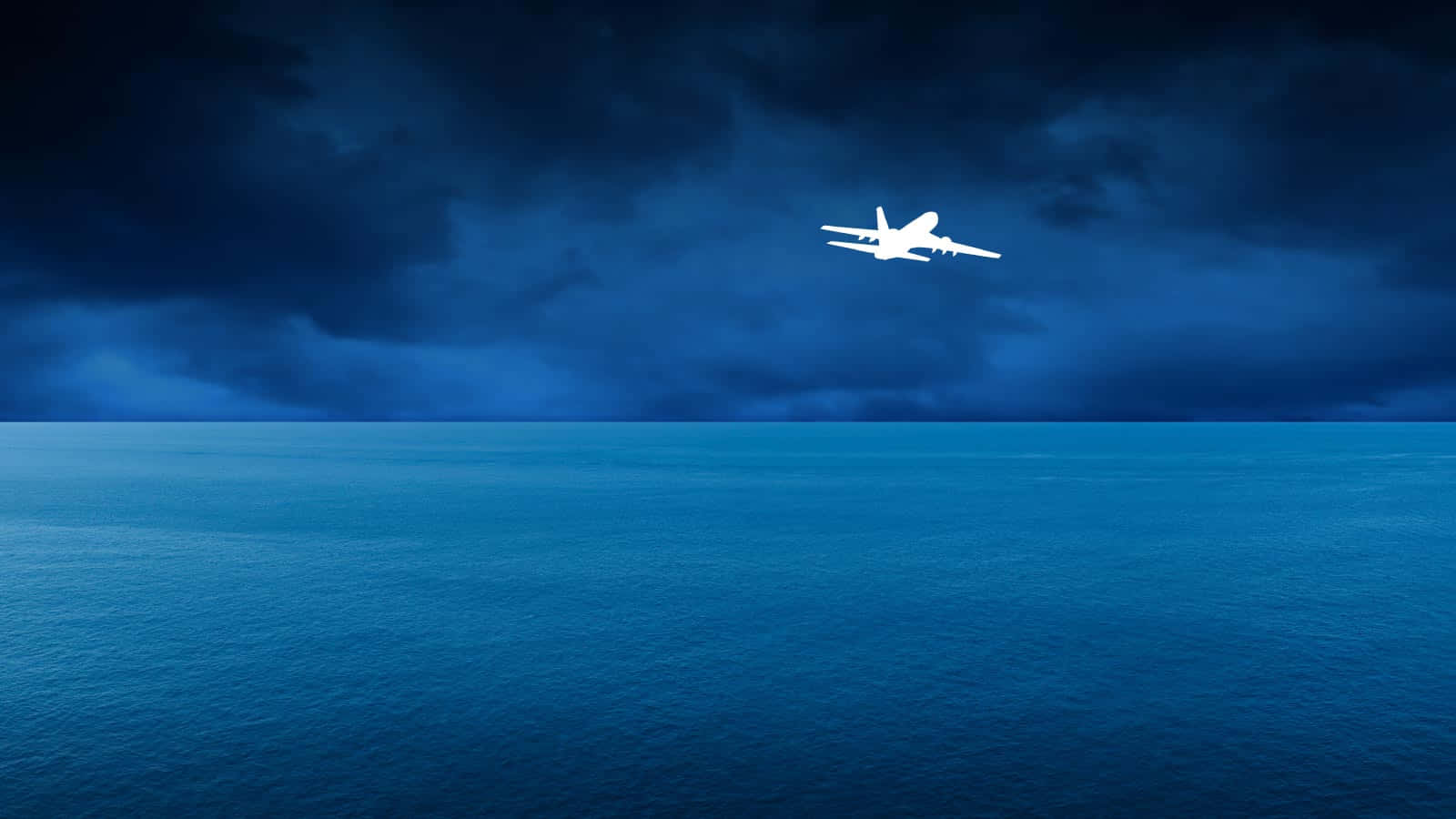 Airplane Over Oceanat Night Wallpaper