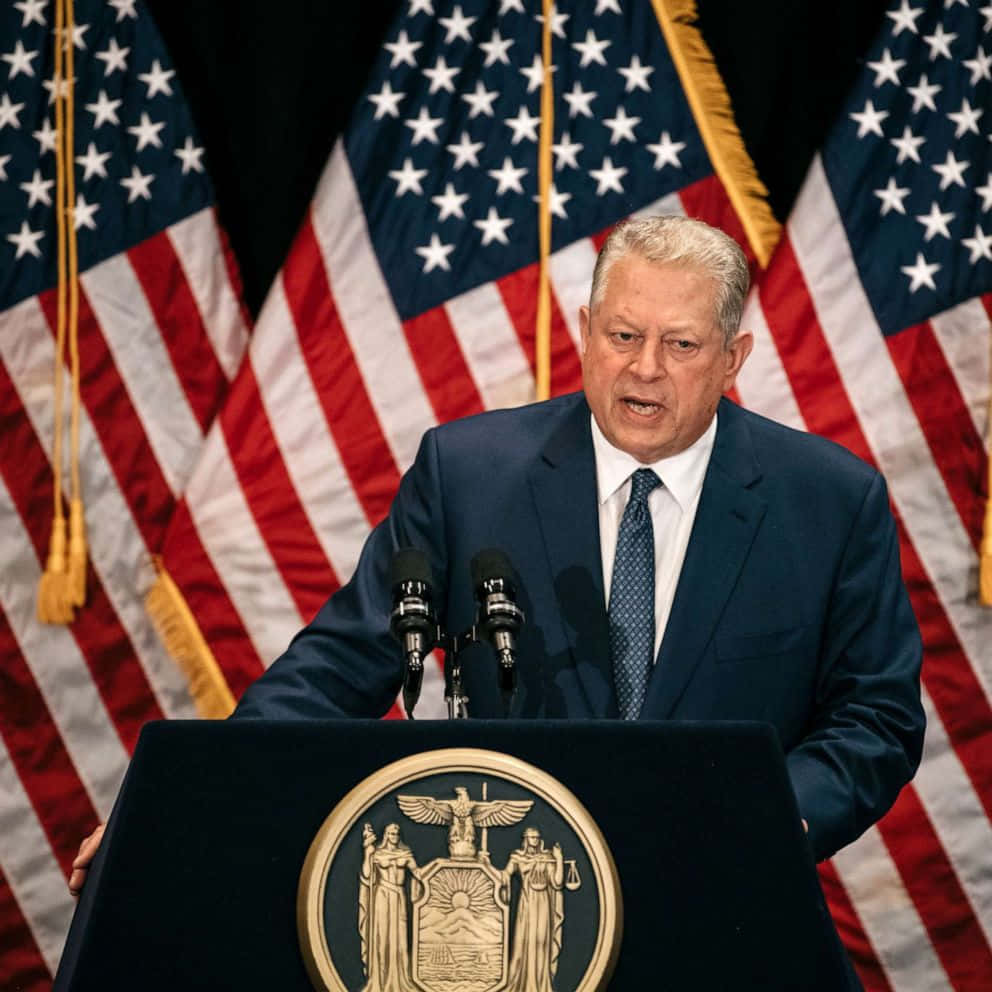 Al Gore Delivering A Speech On An American Themed Podium. Wallpaper