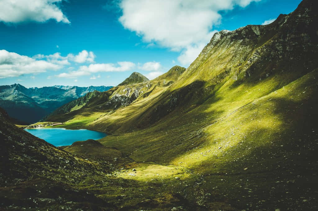 Alpine_ Lake_ Amidst_ Mountain_ Ridges Wallpaper