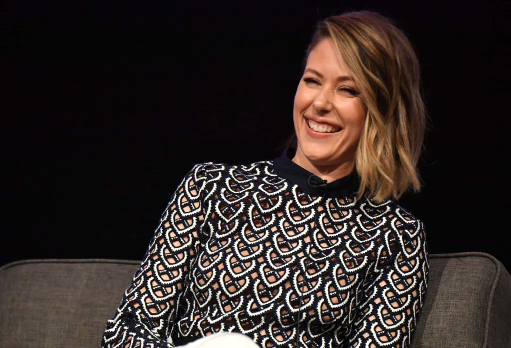 Amanda Crew Smiling During Panel Discussion Wallpaper