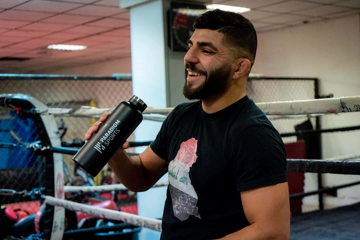 Amir Albazi Holding A Thermal Flask Wallpaper