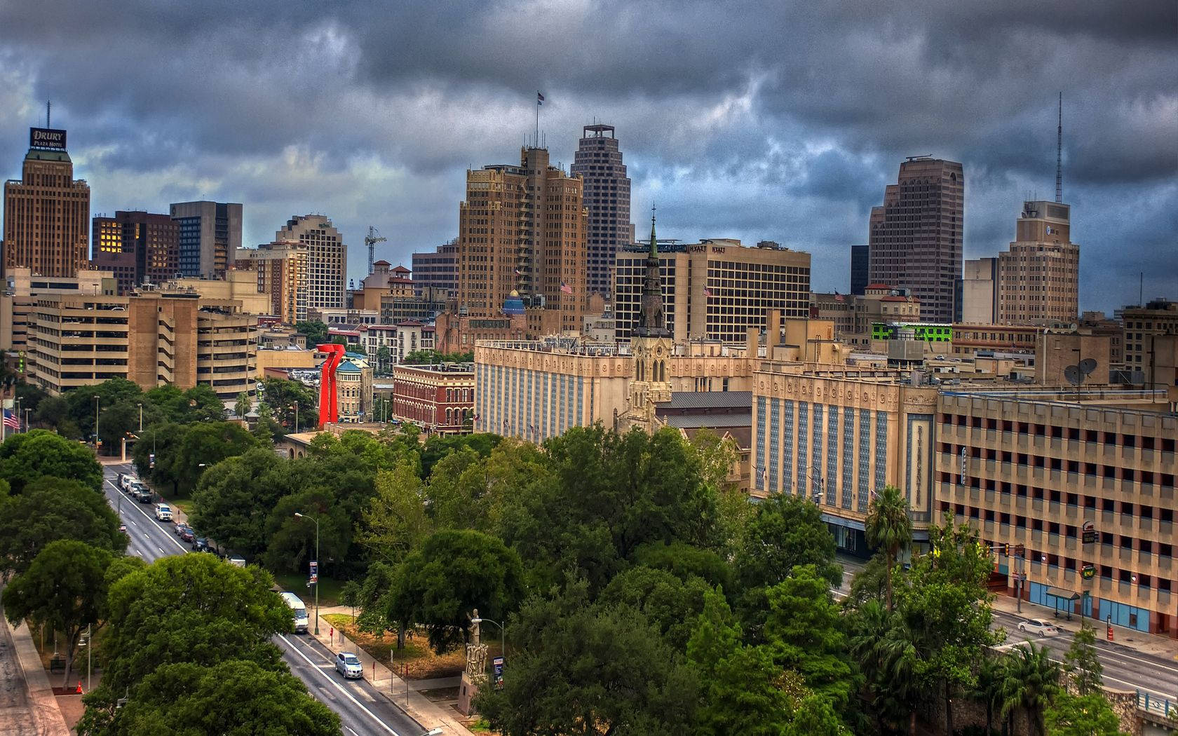 An Aerial View Of San Antonio, Texas, With Its Towering Skyscrapers And Green Trees Wallpaper