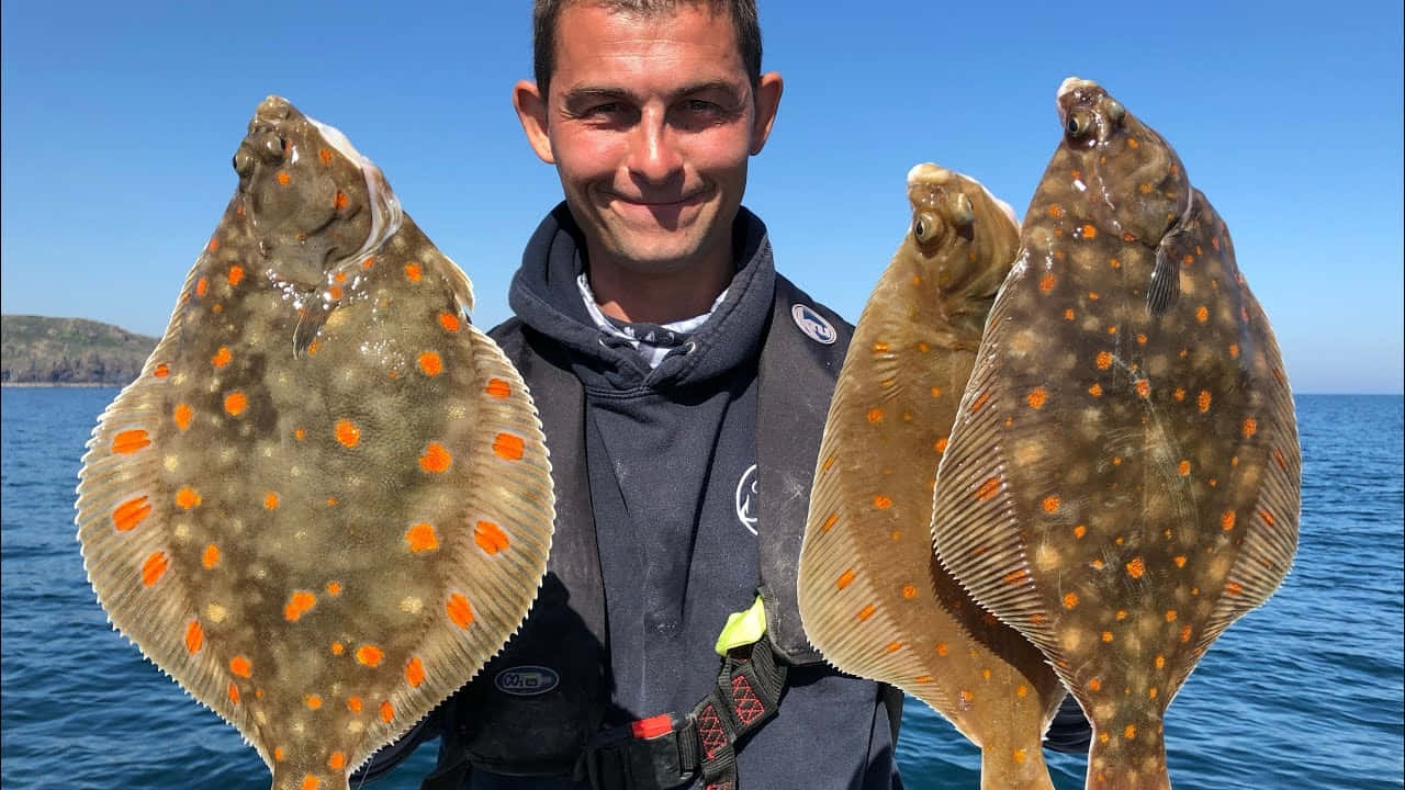 Anglerwith Large Plaice Catch Wallpaper