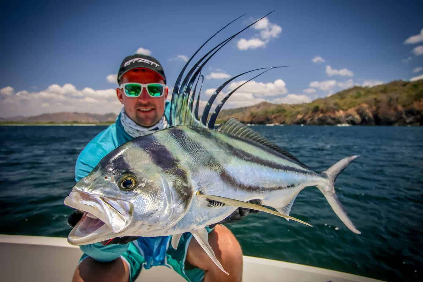 Anglerwith Roosterfish Catch Wallpaper