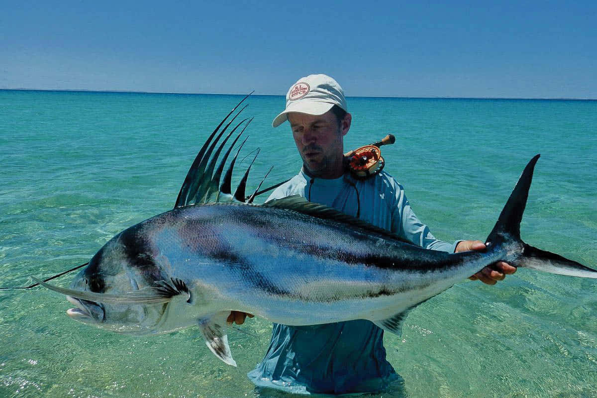 Anglerwith Roosterfish Catch Wallpaper