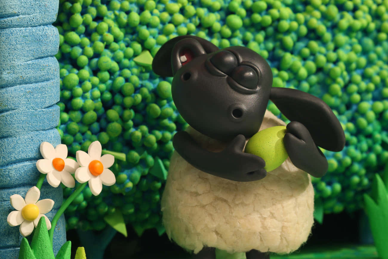 Animated Black Sheep With Tennis Ball Wallpaper