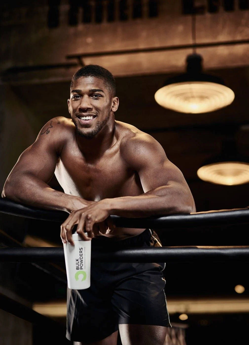 Anthony Joshua Smiling On Ropes Wallpaper