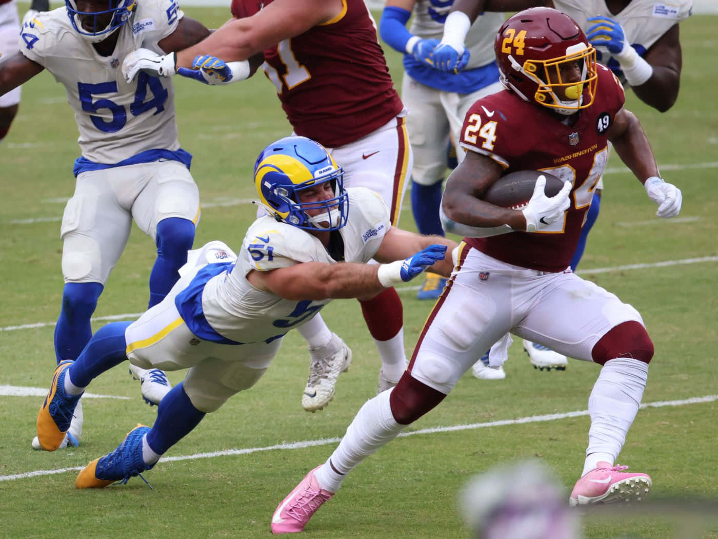 Antonio Gibson Evading Tackle During Game Wallpaper