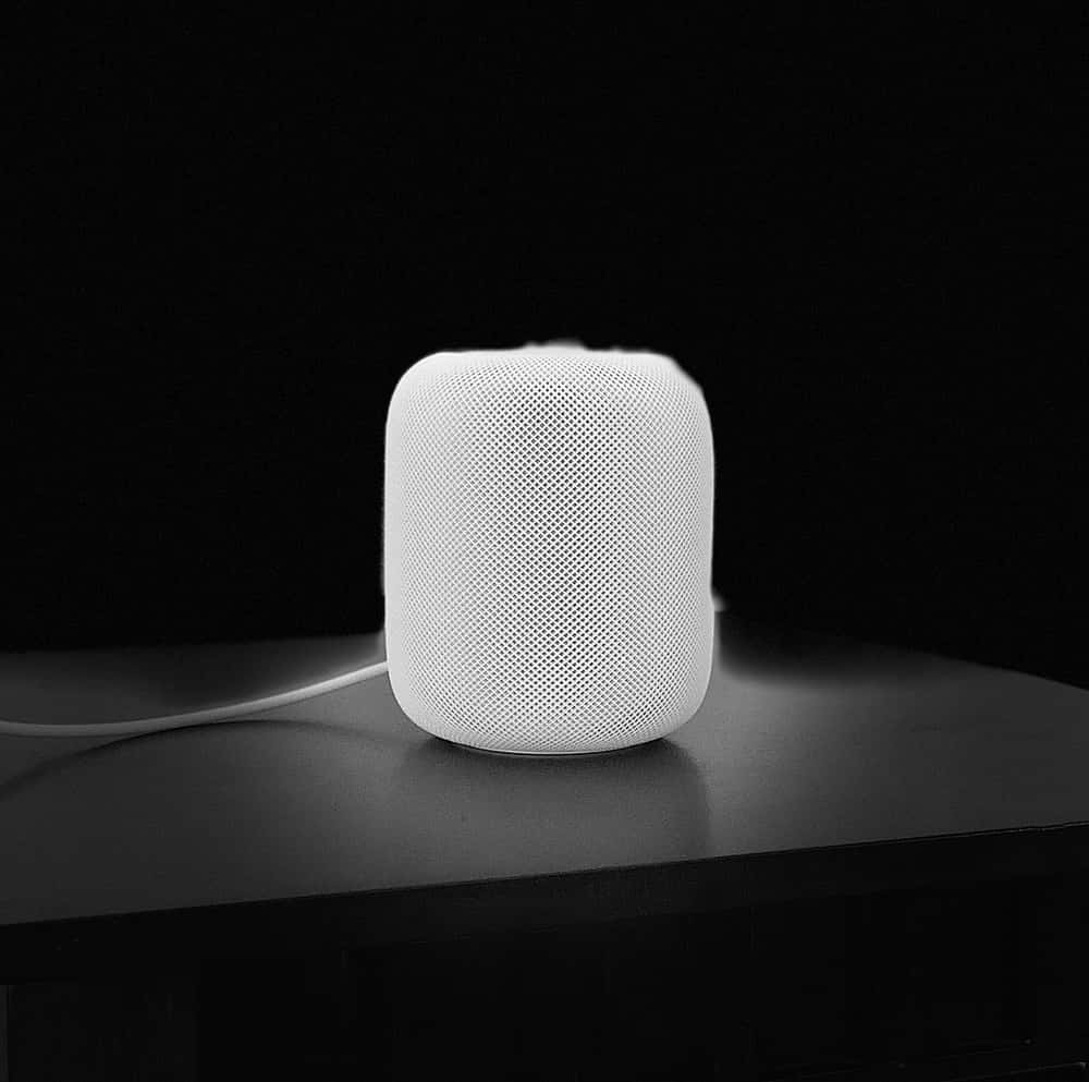 Apple Homepod On A Wooden Table Wallpaper