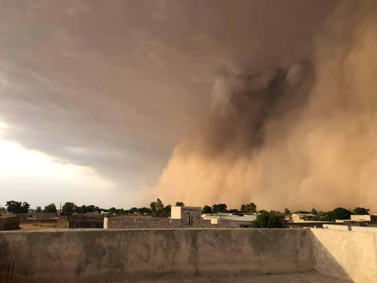 Approaching_ Dust_ Storm_ Over_ Village Wallpaper