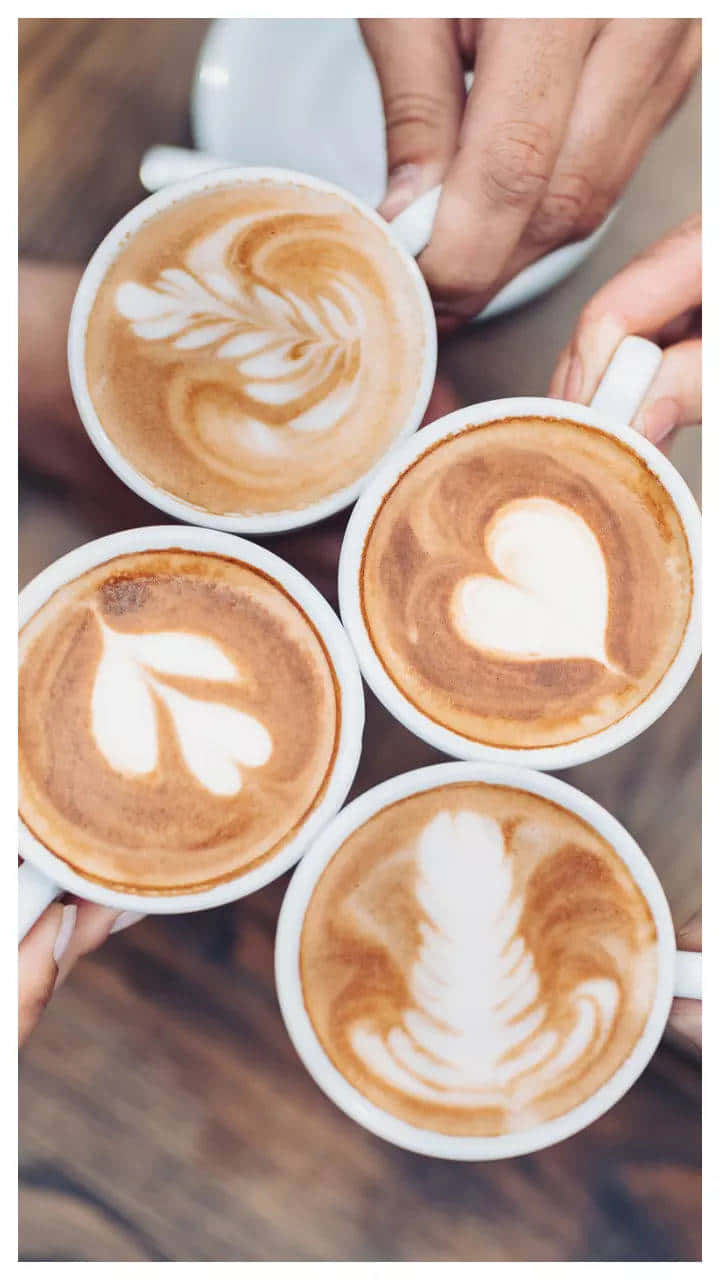 Artistic Latte Coffee Cups Shared Among Friends Wallpaper