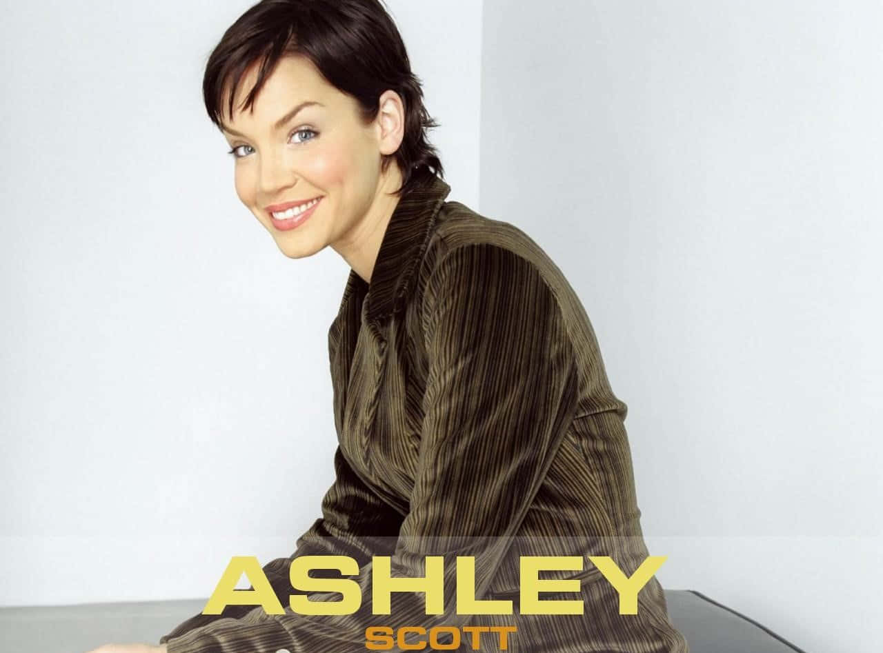 Ashley Scott Striking A Pose In Front Of The Camera Wallpaper