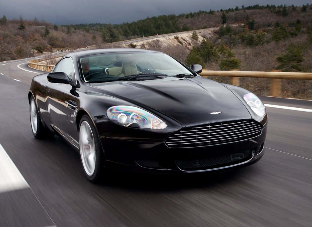 Aston Martin Db9 In A Scenic Landscape Wallpaper