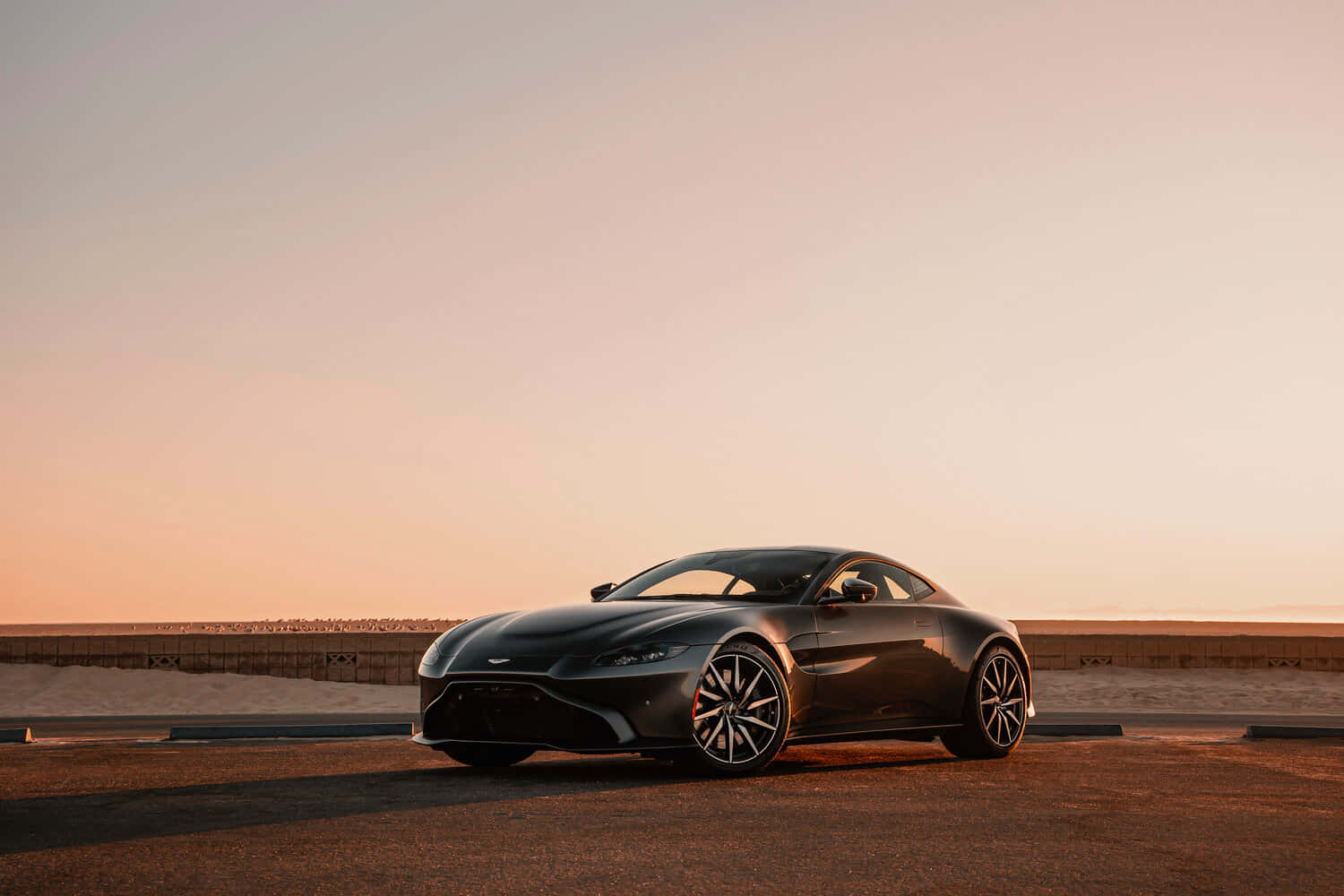 Aston Martin Vantage Driving On A Scenic Route Wallpaper