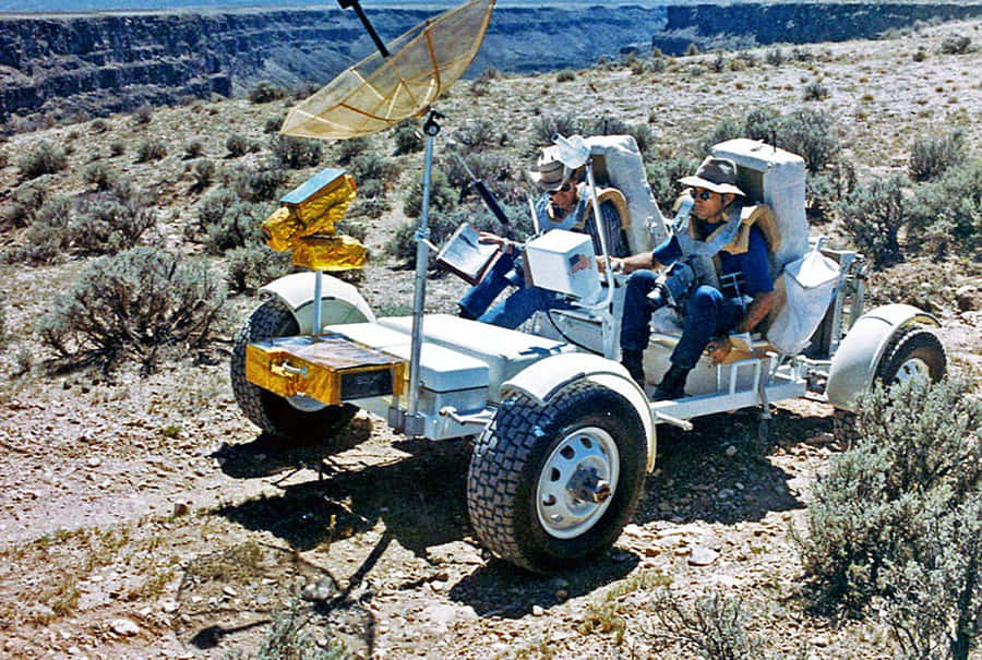 Astronaut Driving The Lunar Rover On The Moon's Surface Wallpaper