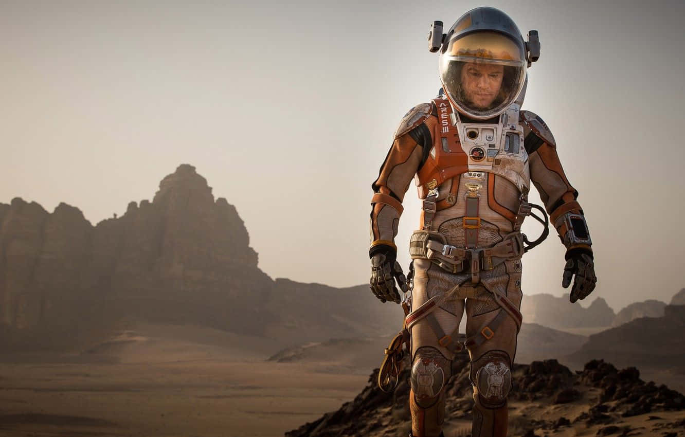 Astronaut Standing On The Mars Surface During A Mission In The Martian Movie Wallpaper