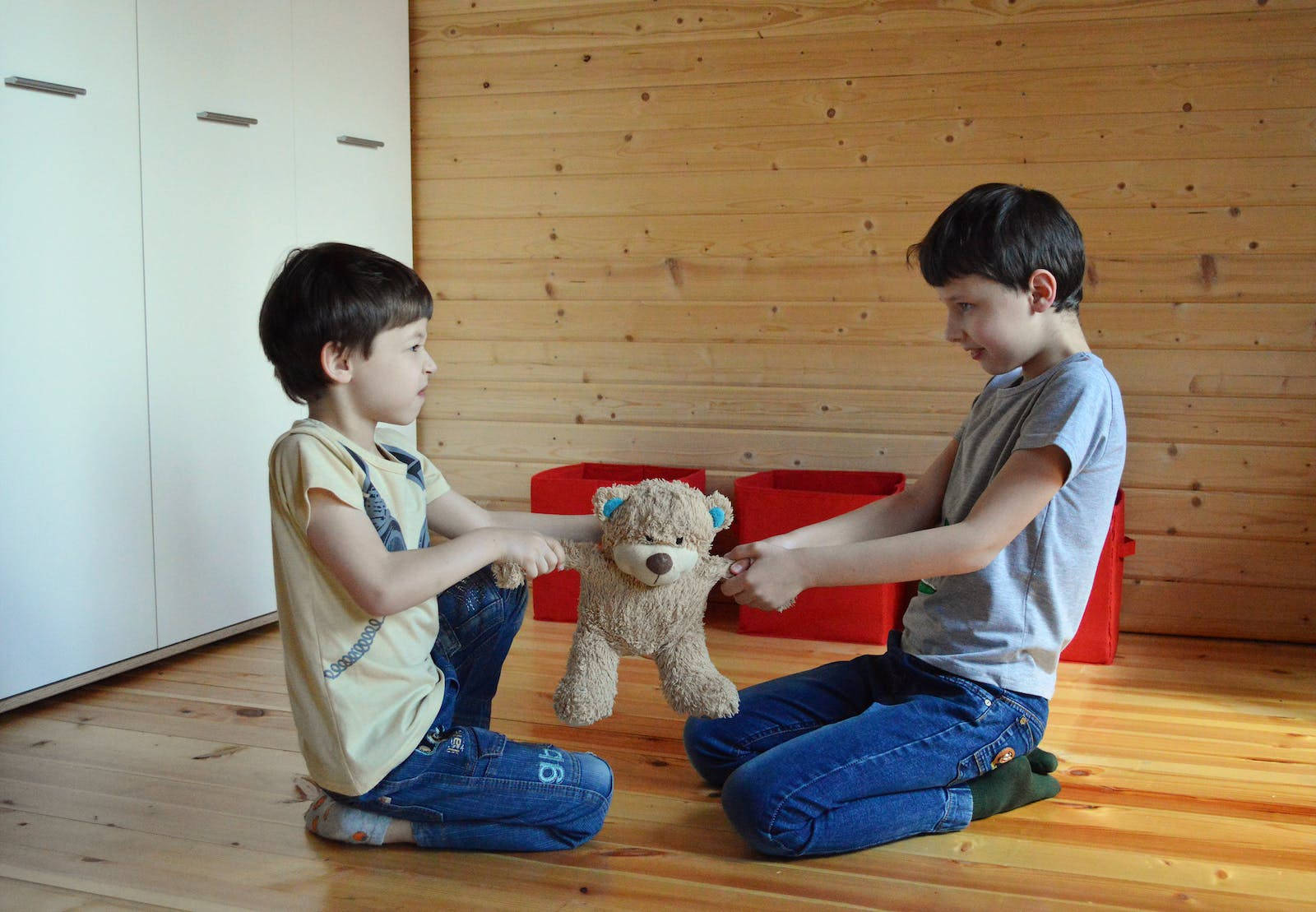 Attitude Boys Fighting Over A Teddy Bear Wallpaper