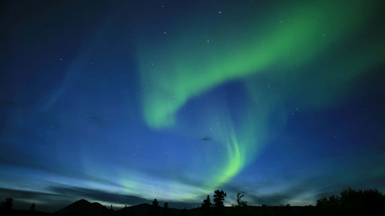 Aurora Australis Over Mountain Silhouettes Wallpaper